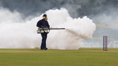 A worker fumigates the field during the Women's World Cup match between India and Pakistan in Colombo in an attempt to remove flying bugs