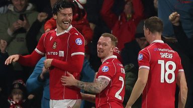 Kieffer Moore celebrates with his Wrexham team-mates after his second goal against Coventry
