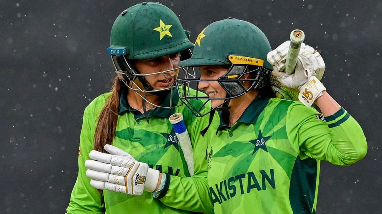 Pakistan's Aliya Riaz (L) and Natalia Pervaiz (R) walk off as it rains against New Zealand at the Women's World Cup (Associated Press)
