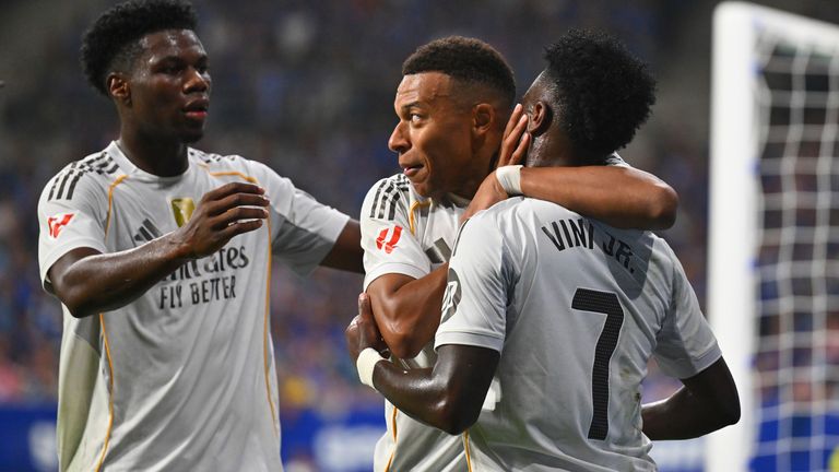 Real Madrid's Kylian Mbappe is congratulated by teammates Vinicius Junior and Aurelien Chuameni after scoring against Oviedo