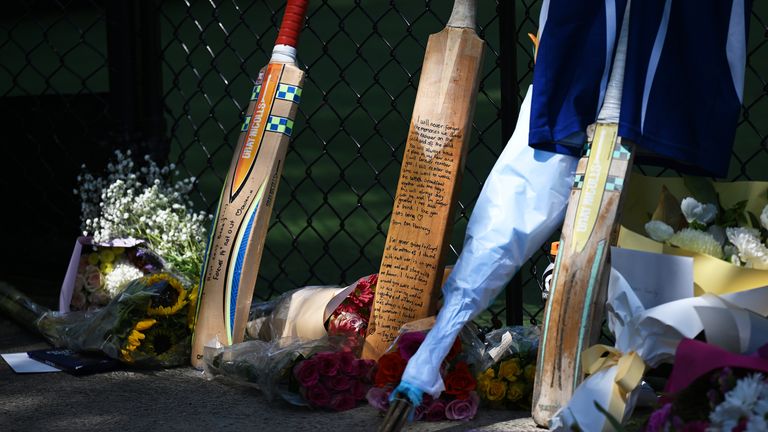 Cricket bats, flowers and notes make an impromptu tribute for teenage cricketer Ben Austin who died in a training accident in Melbourne