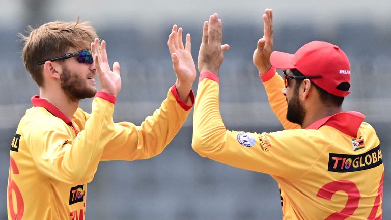 Zimbabwe's Brian Bennett (left) and Sikandar Raza (right) playing T20 international cricket (Getty Images)