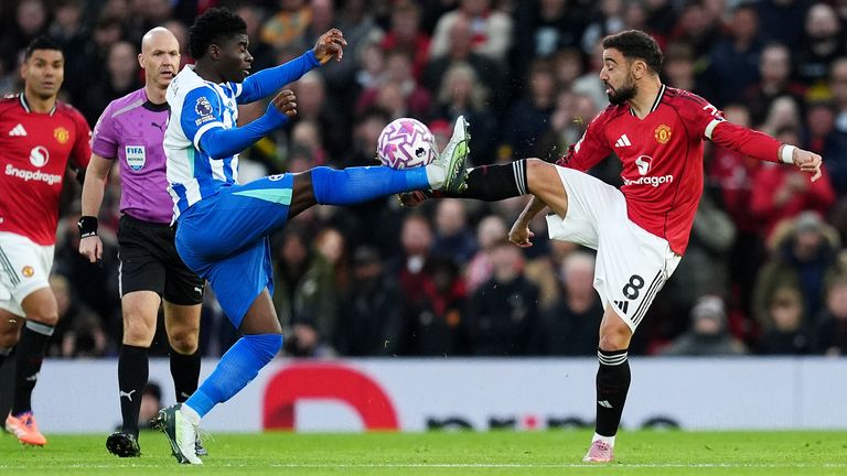 Manchester United's Bruno Fernandes (right) and Brighton's Carlos Baleba battle for the ball