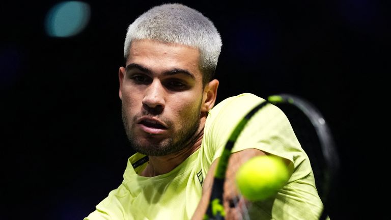 Spain's Carlos Alcaraz plays a backhand return to Britain's Cameron Norrie during their men's singles match on day two of the Paris ATP Masters 1000 tennis tournament at the Paris La D..fense Arena in Nanterre, on the outskirts of Paris, on October 28, 2025. (Photo by Dimitar DILKOFF / AFP)