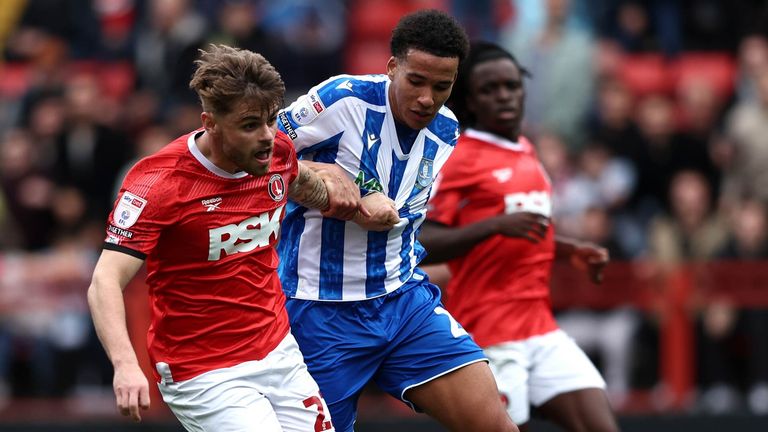 Charlie Kelman is challenged by Liam Palmer