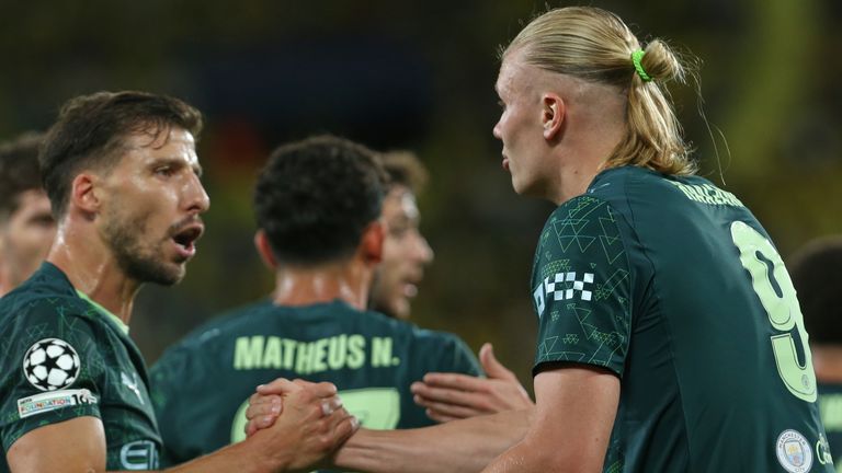 Manchester City's Erling Haaland, right, celebrates with teammates after scoring his side's opening goal