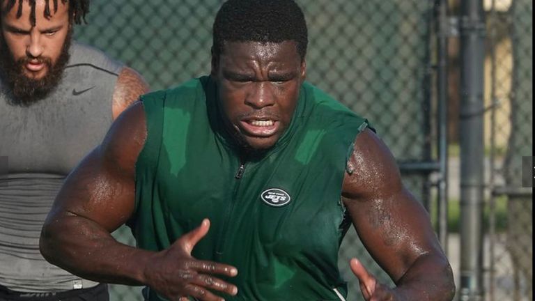 Oram-Jones (pictured in background) working out with NFL legend Frank Gore