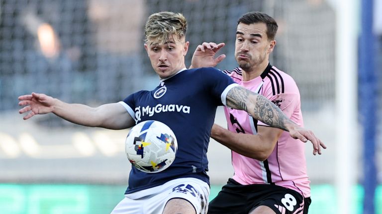 Harry Winks of Leicester City in action with Luke Cundle of Millwall