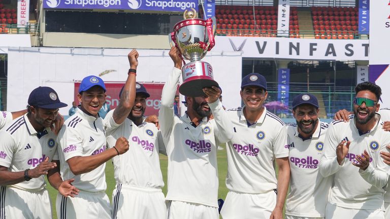 Indian players celebrate with the trophy after wining the India and West Indies test match series at the Arun Jaitley Stadium in New Delhi, India, Tuesday, Oct.14, 2025. (AP Photo/Manish Swarup)