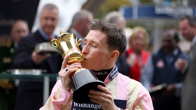 Jason Watson kisses the QEII trophy