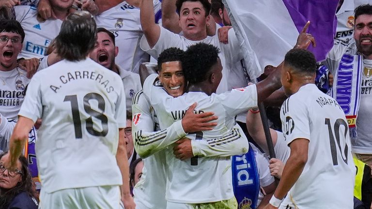 Real Madrid's Jude Bellingham, left, celebrates with teammates after scoring their side's second goal during the Spanish La Liga soccer match between Real Madrid and Barcelona, in Madrid, Sunday, Oct. 26, 2025. (AP Photo/Manu Fernandez)