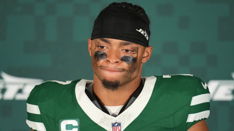 New York Jets quarterback Justin Fields (7) looks down during a press conference after an NFL football game between the Denver Broncos and the New York Jets, Sunday, Oct. 12, 2025, in London. (AP Photo/Kin Cheung)