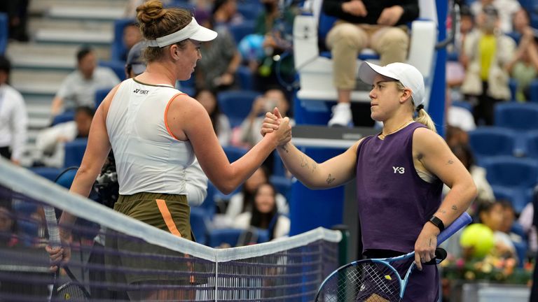 Linda Noskova of the Czech Republic, left shakes hands after defeating Sonay Kartal of Britain in a women's singles quarterfinal match of th