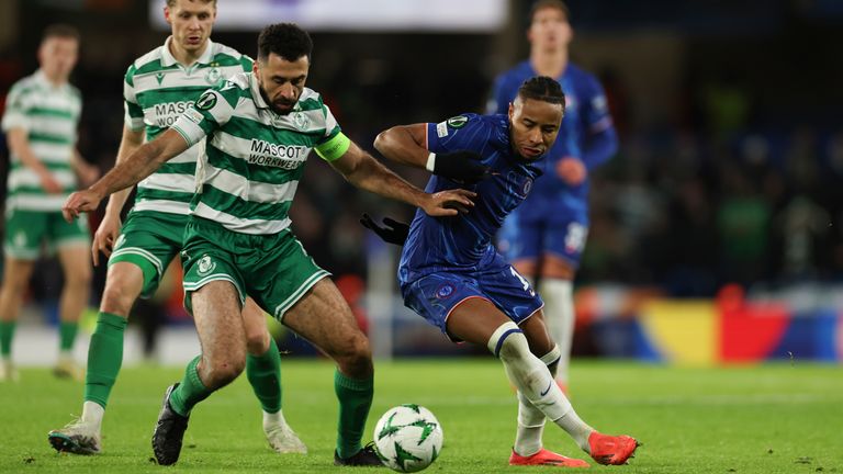 Shamrock Rovers' Roberto Lopes, left, and Chelsea's Christopher Nkunku vie for the ball during the Europa Conference League opening phase soccer match between Chelsea and Shamrock Rovers at Stamford Bridge stadium in London, Thursday, Dec. 19, 2024. (AP Photo/Ian Walton)