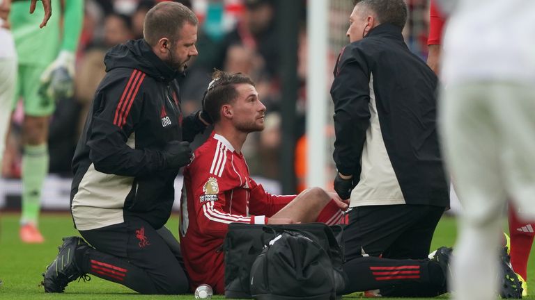 Alexis Mac Allister receives medical attention after suffering a head injury in the build-up to Bryan Mbeumo's opening goal at Anfield