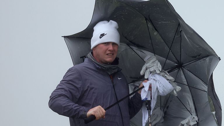 Robert MacIntyre shelters from the weather at the Alfred Dunhill Links