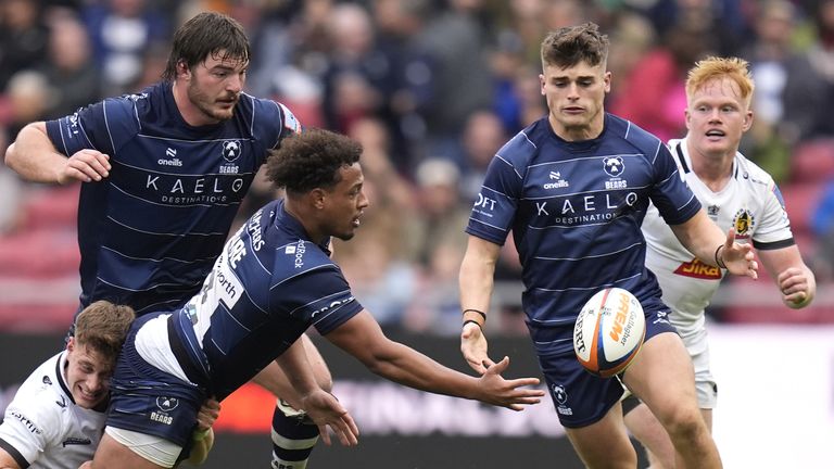 Bristol Bears' Gabriel Oghre offloads the ball after being tackled by Exeter Chiefs' Stephen Varney (left) 