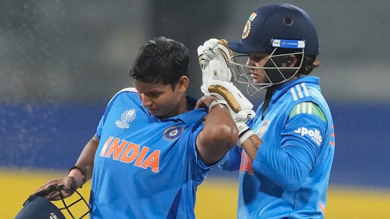 India's Sneh Rana assists team-mate Deepti Sharma in removing bugs that had crawled into her shirt during the game versus Pakistan (AP)