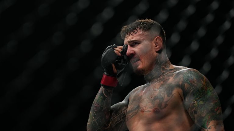 Tom Aspinall compresses his right eye after it was poked by Ciryl Gane during a heavyweight title bout (AP Photo/Altaf Qadri)