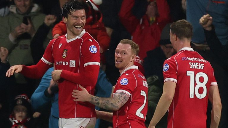 Kieffer Moore celebrates with his Wrexham team-mates after his second goal against Coventry