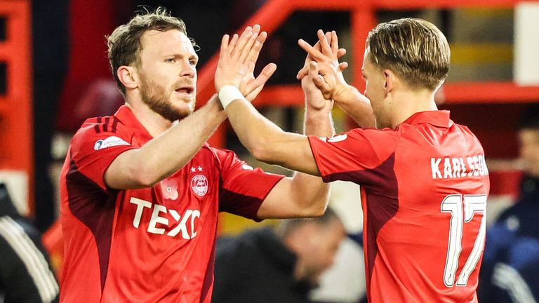ABERDEEN, SCOTLAND - NOVEMBER 09: Aberdeen's Jesper Karlsson (R) celebrates with Nicky Devlin after scoring to make it 1-0 during a William Hill Premiership match between Aberdeen and Motherwell at Pittodrie Stadium, on November 09, 2025, in Aberdeen, Scotland. (Photo by Ross MacDonald / SNS Group)