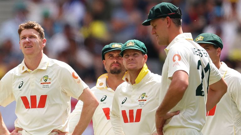 Brendan Doggett of Australia watches the big screen with team mates while waiting on the 3rd umpires decision