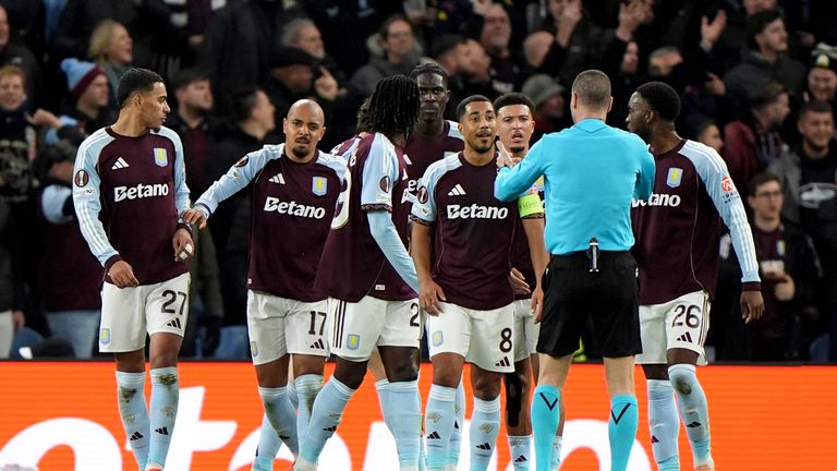 Aston Villa players speak to the referee after Aston Villa's Donyell Malen was hit by an object from the away fans