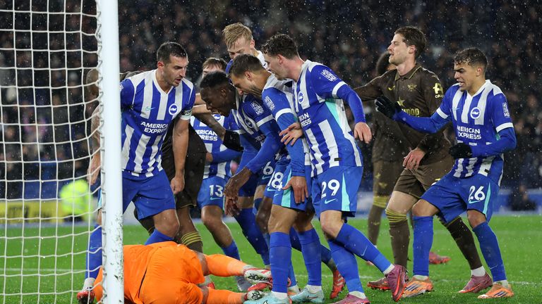 Brighton players surround their goalkeeper