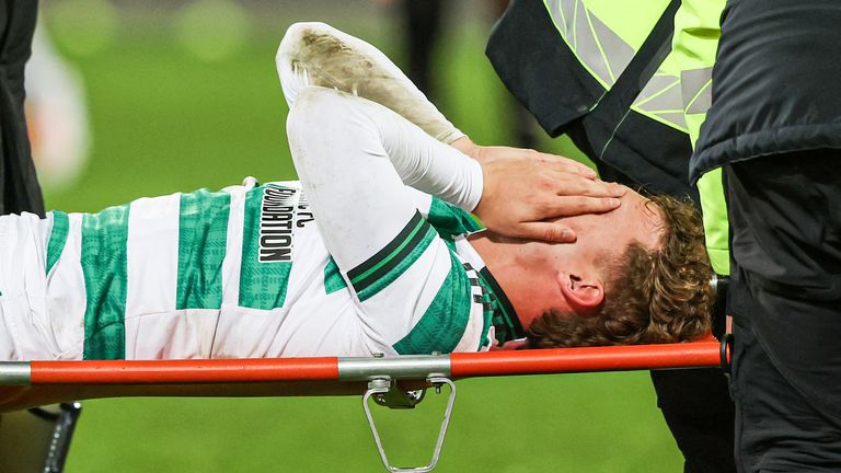  Celtic's Callum Osmand looks dejected as he is taken off on a stretcher due to an injury