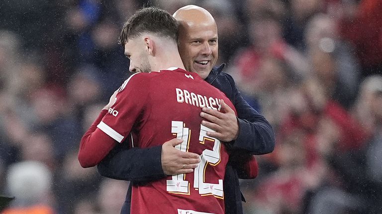 Conor Bradley hugs Arne Slot after Liverpool's win over Real Madrid in the Champions League