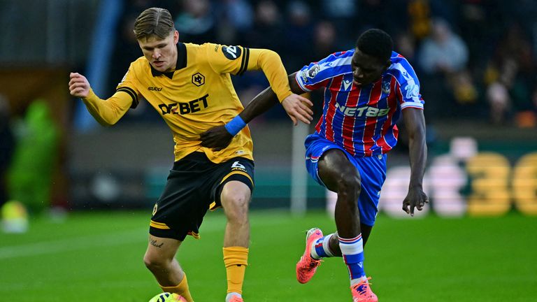 David Moller Wolfe and Ismaila Sarr in Premier League action at Molineux