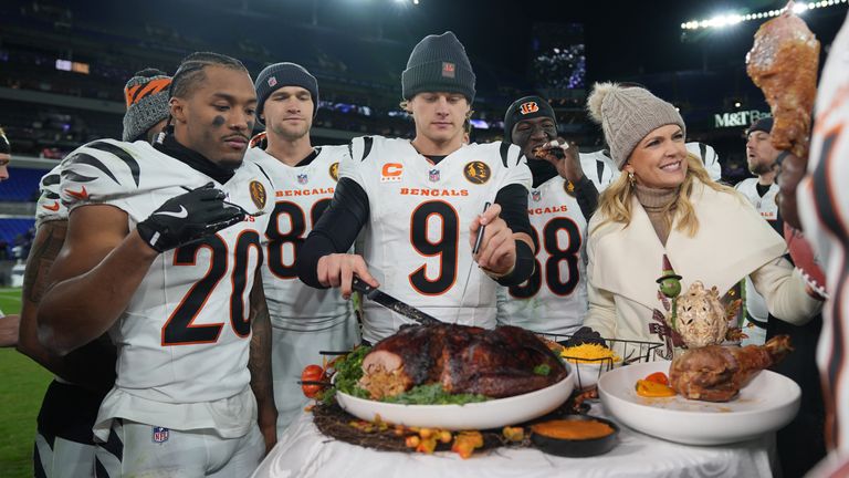 Cincinnati Bengals quarterback Joe Burrow (9) joined by NBC Sports sideline reporter Melissa Stark, right, teammates DJ Turner II (20), Mike