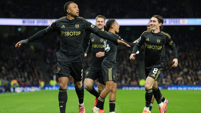 Fulham's Kenny Tete, left, celebrates with Harry Wilson after scoring the opening goal during the English Premier League soccer match between Tottenham Hotspur and Fulham in London, Saturday, Nov. 29, 2025. (AP Photo/Ian Walton)