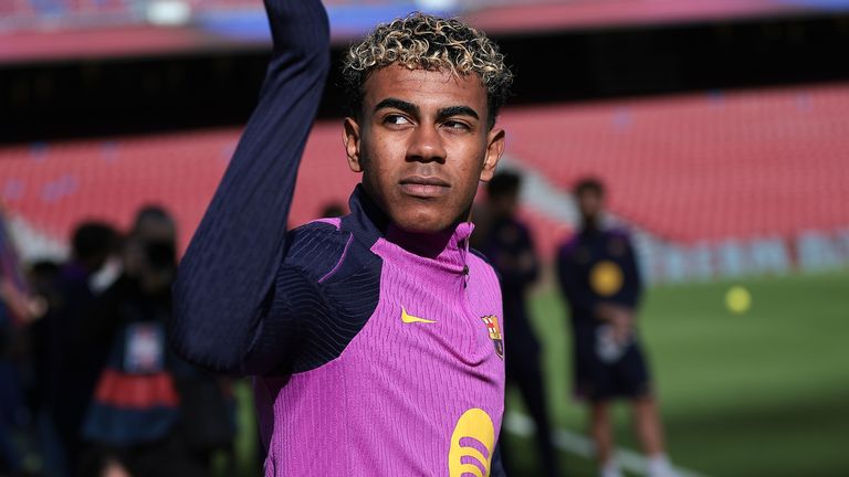 Lamine Yamal waves towards fans during a Barcelona training session at Nou Camp on November 7, 2025