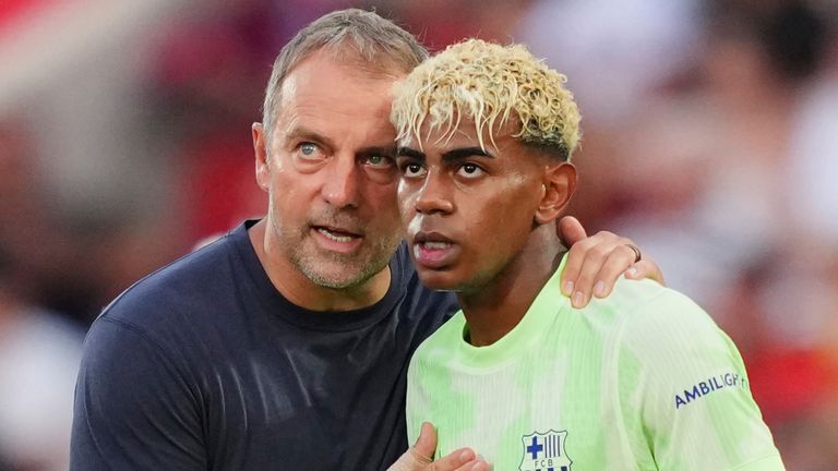 Barcelona's head coach Hansi Flick talks to Lamine Yamal 