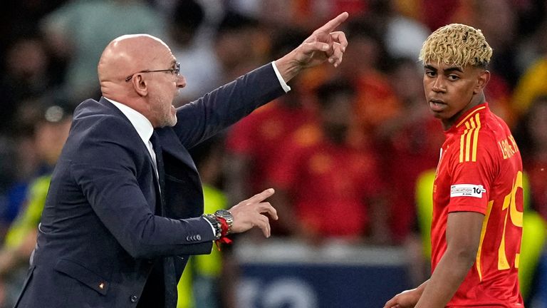 Spain's head coach Luis de la Fuente gives instructions beside Spain's Lamine Yamal 