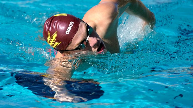French Olympic swimmer Leon Marchand trains with his Arizona State University  teammates, Tuesday, Feb. 13, 2024, in Tempe, Ariz. With family and friends ... an entire nation ... watching, the individual medley specialist is poised to be one of the premier faces of these Olympics. (AP Photo/Ross D. Franklin)