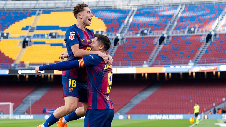 Robert Lewandowski celebrates with his teammate Fermin Lopez