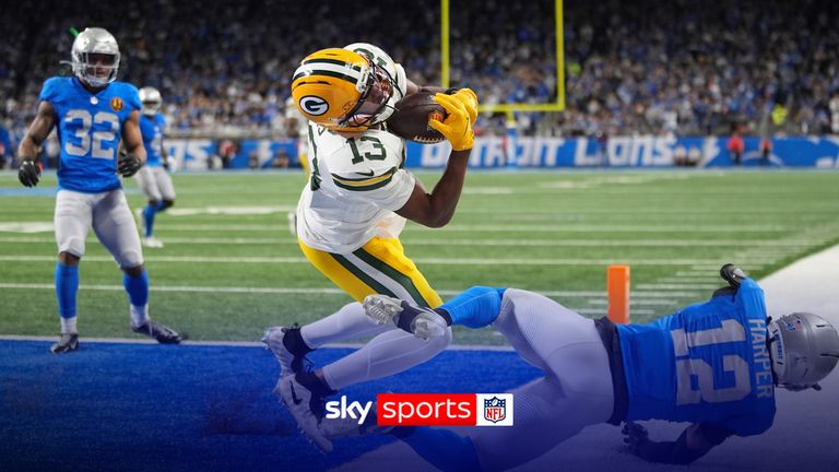 Green Bay Packers wide receiver Dontayvion Wicks (13) makes a catch for a touchdown over Detroit Lions safety Thomas Harper (12) during the first half an NFL football game in Detroit, Thursday, Nov. 27, 2025.