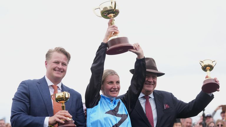 Jamie Melham holds her trophy aloft after riding Half Yours to win the Melbourne Cup (AP Photo/Asanka Brendon Ratnayake)