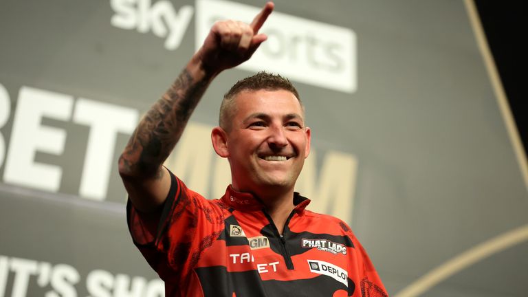 Nathan Aspinall celebrates victory against Michael van Gerwen in their quarter-final match at the BetMGM Premier League 2025