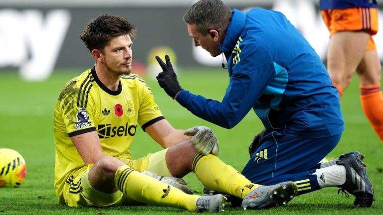 Nick Pope is assessed by Newcastle medical staff after landing awkwardly