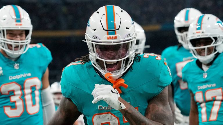 Miami Dolphins running back Ollie Gordon II (31), center, reacts after scoring a touchdown during the second half of an NFL football game between the Washington Commanders and the Miami Dolphins in Madrid, Spain, Sunday, Nov. 16, 2025. (AP Photo/Bernat Armangue)