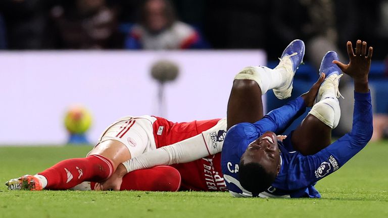 Moises Caicedo falls to the turf after fouling Mikel Merino, a challenge for which he receives a red card