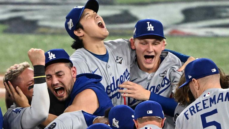 Los Angeles Dodgers two-way player Shohei Ohtani (back center) and players celebrate after their win against the Toronto Blue Jays in Game Seven of the MLB World Series at Rogers Centre in Toronto on November 2, 2025. The Dodgers won the World Series for the second consecutive year. ( The Yomiuri Shimbun via AP Images )