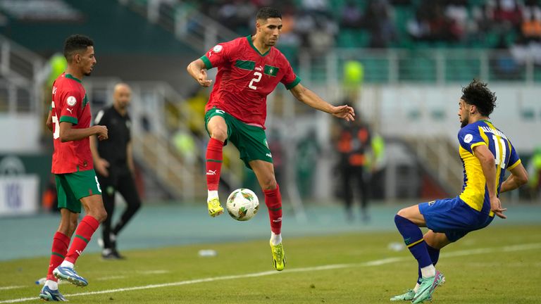 Morocco's Achraf Hakimi, centre, controls the ball in the air ahead of Tanzania Tarryn Allarakhia during the African Cup of Nations Group F soccer match between Morocco and Tanzania at the Laurent Pokou stadium in San Pedro, Ivory Coast, Wednesday, Jan. 17, 2024. (AP Photo/Themba Hadebe)