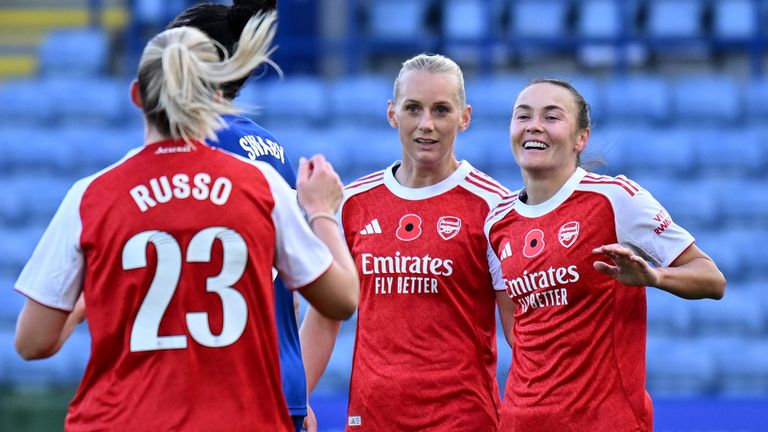 Caitlin Foord and Stina Blackstenius celebrate after an own goal gives Arsenal a 2-0 lead at Leicester