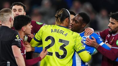 Danny Welbeck and West Ham's Mateus Fernandes are held back from each other after the Brighton forward misses his penalty