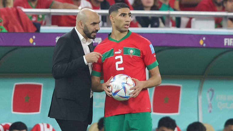 Walid Regragui in conversation with Achraf Hakimi during Morocco's World Cup campaign