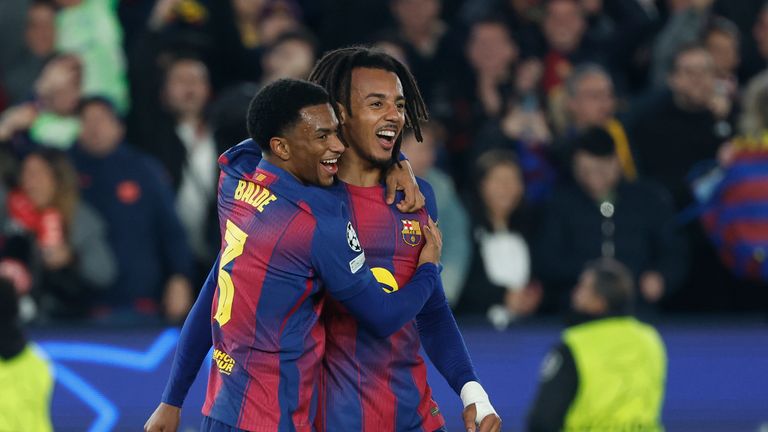 Barcelona's Jules Kounde right, celebrates with Alejandro Balde after scoring his side's second goal during the Champions League opening phase soccer match between Barcelona and Eintracht Frankfurt in Barcelona, Spain, Tuesday, Dec. 9, 2025. (AP Photo/Joan Monfort)
